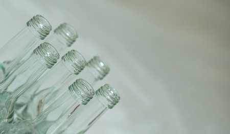 neat bottle display, stylish and tranquil depiction of glass bottles with ecofriendly and beverage themesの写真素材