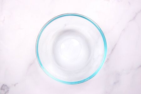 Empty glass bowl on white marble backgroundの写真素材