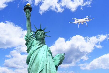 Drone quadrocopter flying next to the Statue of Liberty in New York, USA. Freedom and surveillance conceptの写真素材