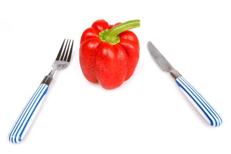 Red bulgarian pepper knife and fork  isolated on white の写真素材