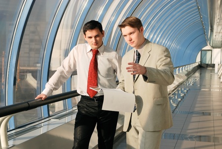 Two young businessmen on meeting talking the documentの写真素材
