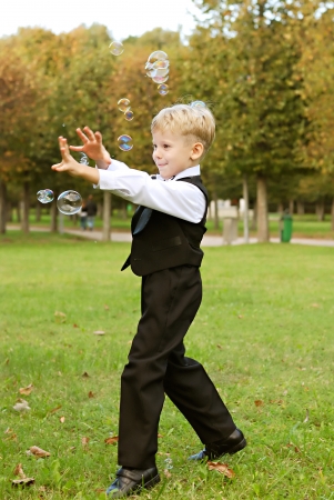 young boy playing with soap bubblesの写真素材