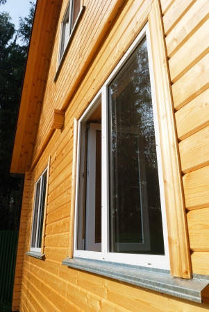 Plastic windows of modern wooden Russian traditional houseの写真素材