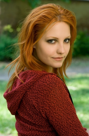 Outdoor portrait of gorgeous young redhead girl in the park.の写真素材