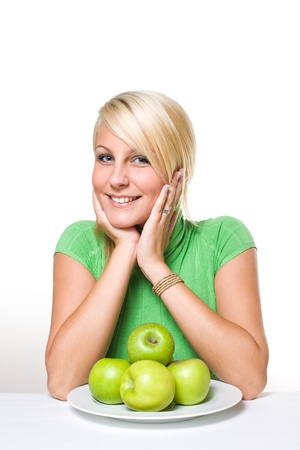 Diet concept - portrait of fresh young blond with fresh green apples.の写真素材