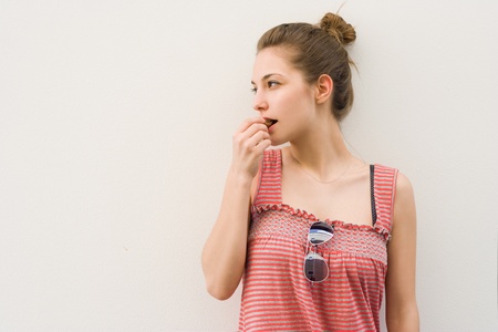 Portrait of a beautiful young brunette having chocolate snack.の写真素材