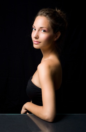 Elegant beauty shot of a gorgeous young brunette with black background.の写真素材