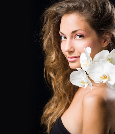 Gorgeous brunette closeup beauty shot with white orchid.の写真素材