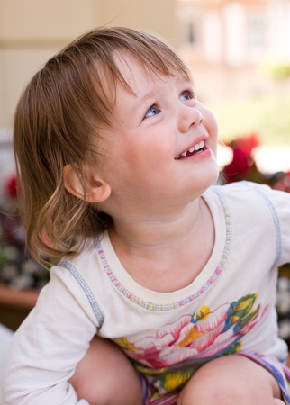 Outdoors portrait of charming baby toddler girl having fun.の写真素材