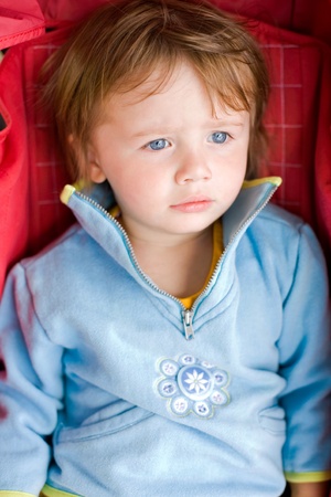portrait of young toddler baby girl in the stroller.の写真素材
