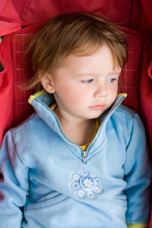 portrait of young toddler baby girl in the stroller.の写真素材