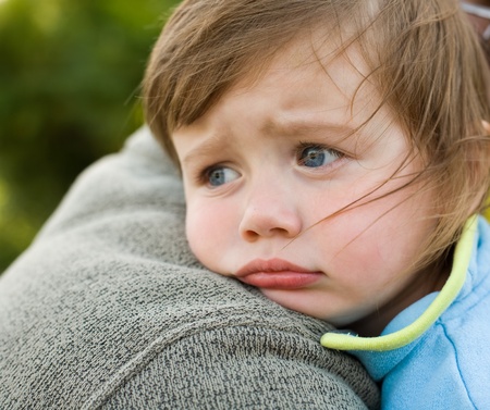 closeup portrait of young toddler baby girl resting on daddyの写真素材
