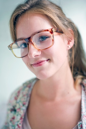 Closeup portrait of Cute smart looking friendly blond girl.の写真素材