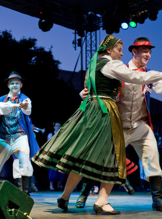 EGER - AUGUST 18: Traditional Polish folk dance performers on stage at night, as part of the St Sephenのeditorial素材