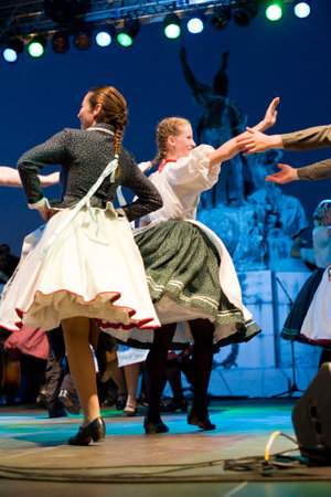 EGER - AUGUST 18: Traditional Hungarian folk dance performers on stage at night, as part of the St Sephenのeditorial素材