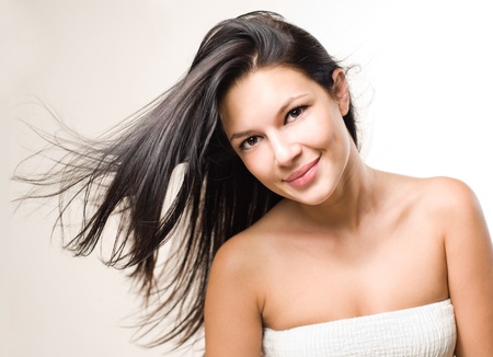 Dynamic beauty shot of gorgeous brunette with flowing hair.の写真素材