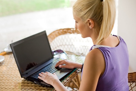 Gorgeous young blond working on her laptop.の写真素材