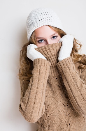 Beautiful winter fashion girl inplaying with her turtleneck sweater.の写真素材