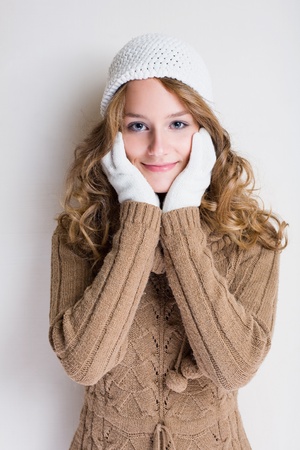 Portrait of cheerful winter fashion girl warming up for the cold season.の写真素材