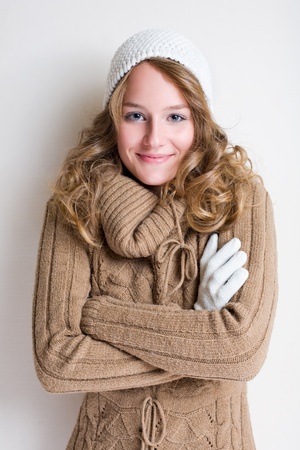Portrait of cheerful winter fashion girl warming up for the cold season.の写真素材