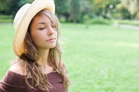 Portrait of gorgeous fashionable young brunette woman with dreamy expression, eyes closed.の写真素材