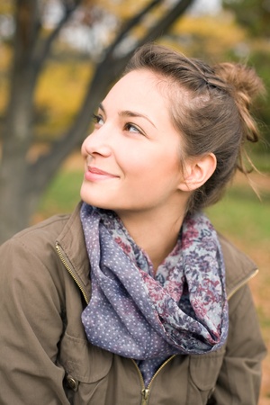 Portrait of Beautiful happy girl outdoors in the park at autumn.の写真素材
