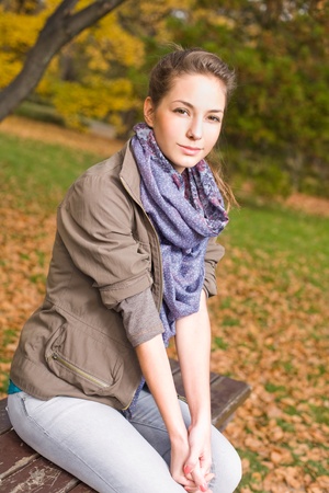 Portrait of Beautiful happy girl outdoors in the park at autumn.の写真素材