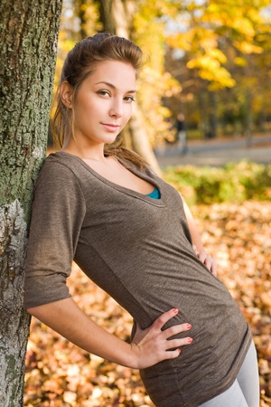 Gorgeous brunette posing in the park at fall.の写真素材