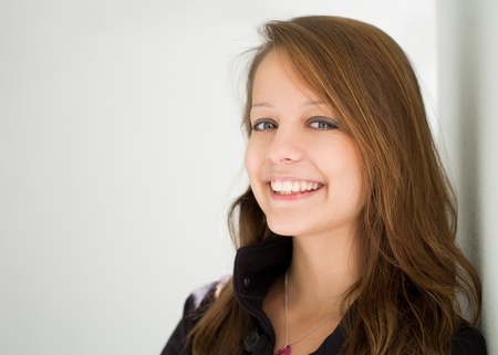 Closeup portrait of beautiful happy brunette teen with copy space.の写真素材