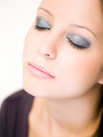 Closeup portrait of beautiful young brunette woman in light makeup.の写真素材