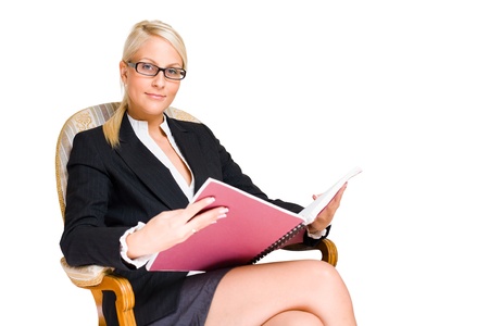 Rich young busness woman sitting in expensive antique chair.の写真素材