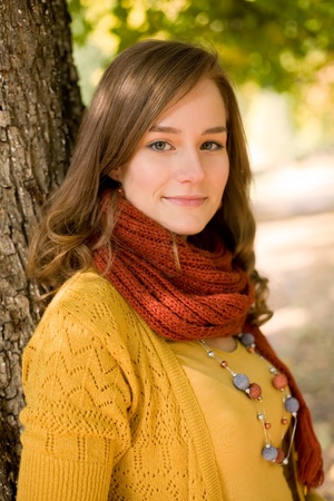 Outdoors portrait of beautiful colorful fall fashion woman.の写真素材