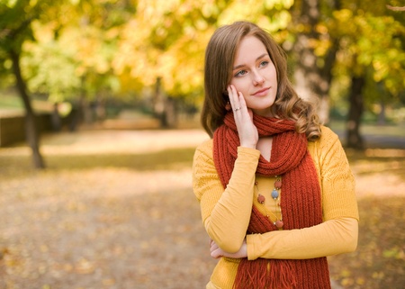 Portrait of colorful fall fashion woman with pondering gesture.の写真素材