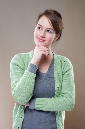 Gorgeous young brunette woman in pondering posture.の写真素材