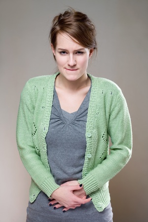 half length portrait of a young brunette woman with very painful expression.の写真素材