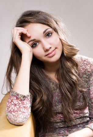 Portrait of a beautiful friendly young brunette teen girl.の写真素材