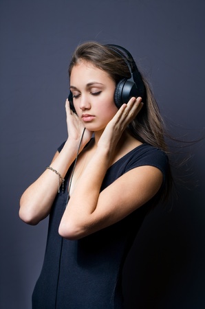 Portrait of a tranquil young brunette immersed in music.の写真素材