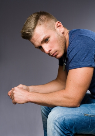 The thinker, portrait of a handsome young man pondering.の写真素材