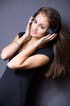Gorgeous brunette girl listening to music in headphones.の写真素材