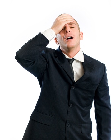 Forgetful young businessman gesturing with surprise, isolated on white.の写真素材