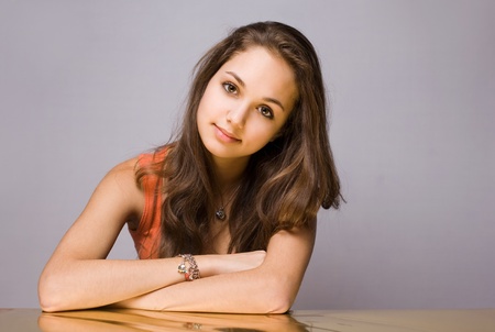 Artistic portrait of confident young brunette with golden reflection hue.の写真素材