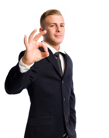 Half length portrait of an elegant businessman showing o.k. sign.の写真素材