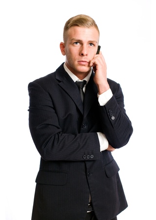 Half length portrait of a handsome young businessman using his cellphone.の写真素材