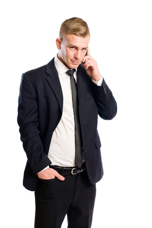 Half length portrait of a handsome young businessman using his cellphone.の写真素材