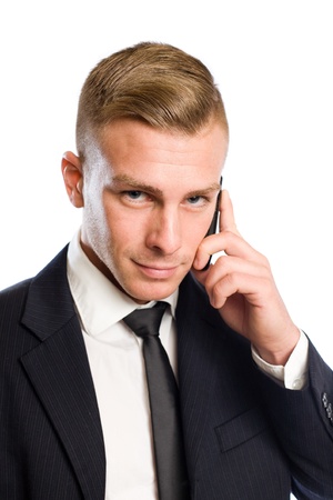 Portrait of a handsome young businesman being busy on the phone.の写真素材