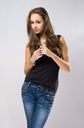 Portrait of a gorgeous slender young brunette jeans model.の写真素材