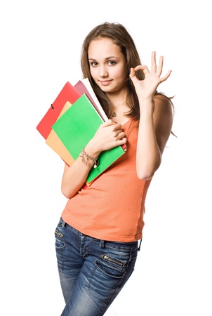 Gorgeous young brunette student girl showing o.k. isolated on white background.の写真素材