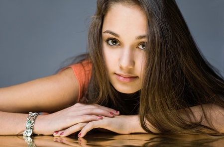 Golden girl, portrait of a sweet beautiful young brunette with gold reflections.の写真素材