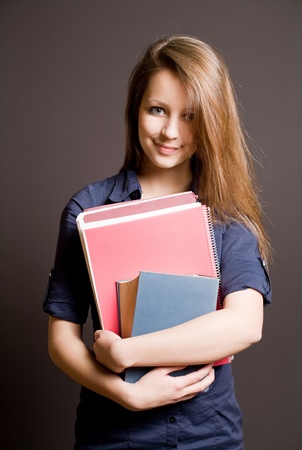 Half length portrait of a beautiful smiling young student girlの写真素材