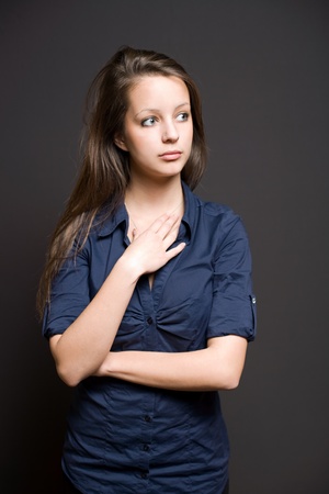 Half length portrait of a thoughtful looking young brunette student.の写真素材
